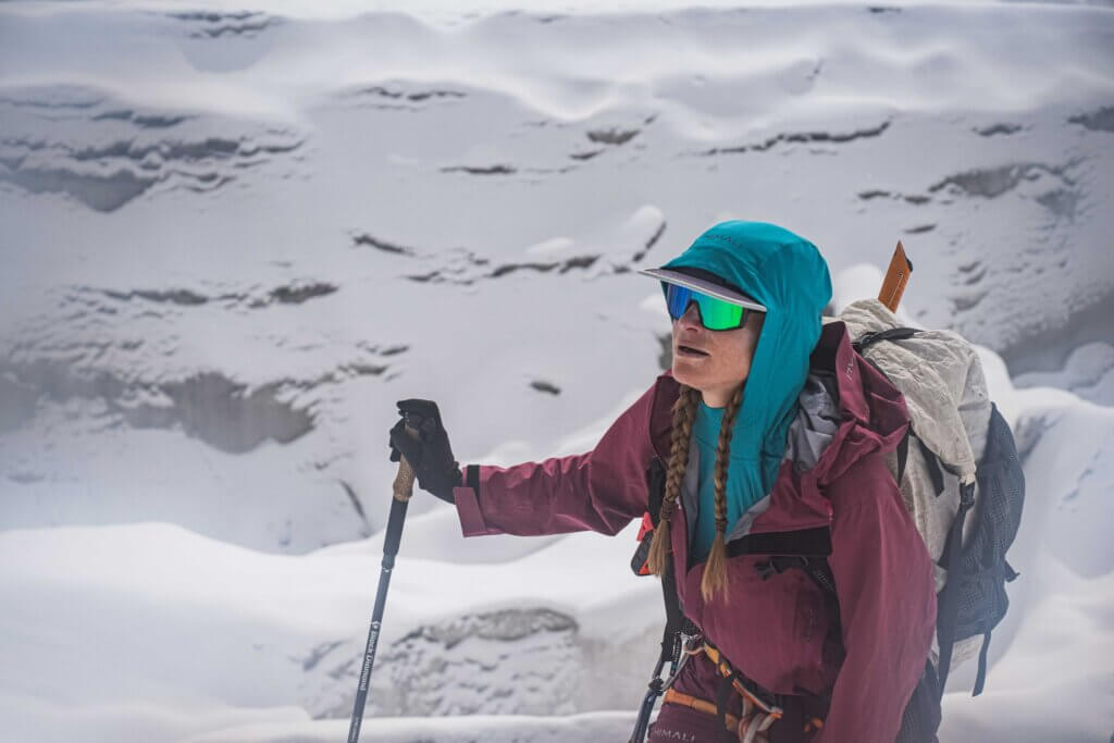 Allie Pepper with a backpack and trekking pole on Manaslu