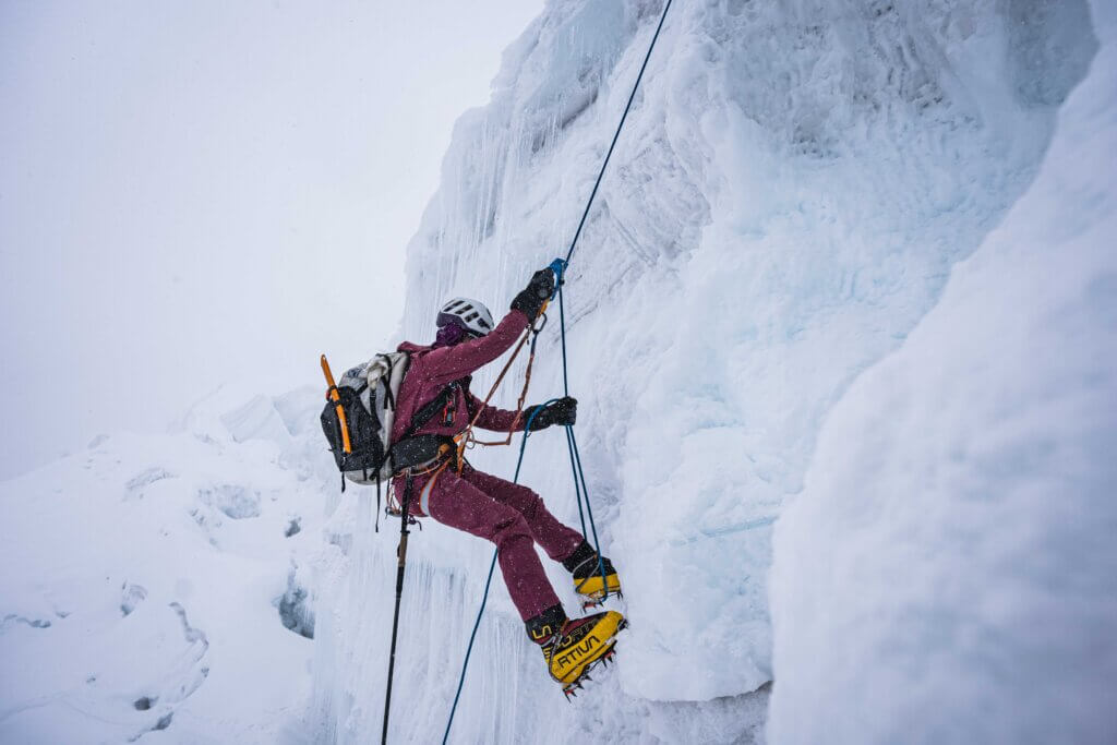 Allie Pepper ascending a fixed rope beside an ice wall on Manaslu